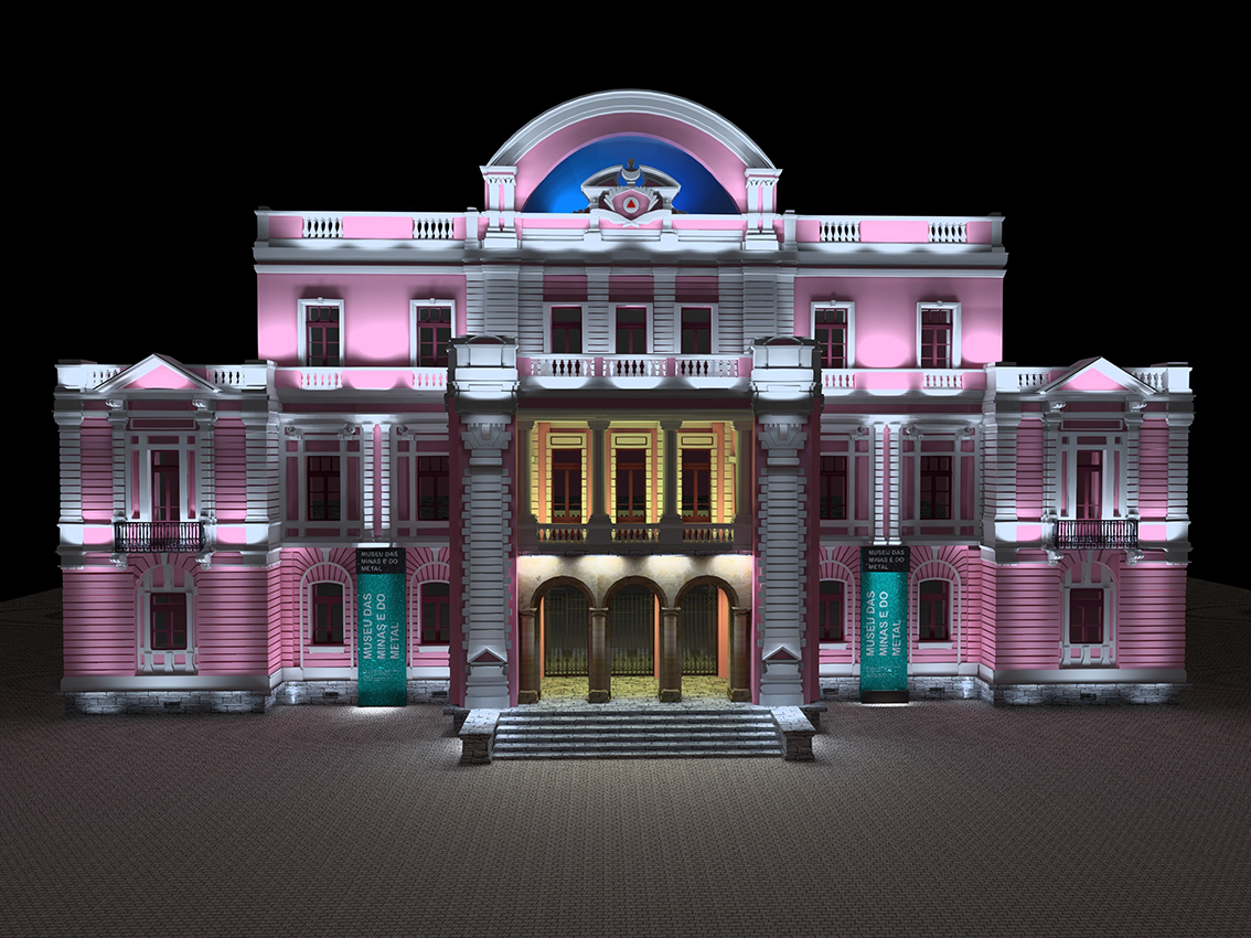 Fachada do Museu das Minas e do Metal iluminada em rosa e âmbar